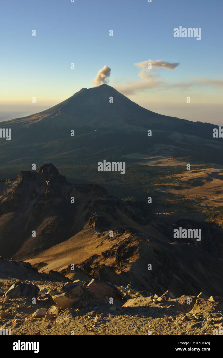 Popocatépetl in early morning light with ash eruption, view from Iztaccíhuatl, Mexico Stock Photo