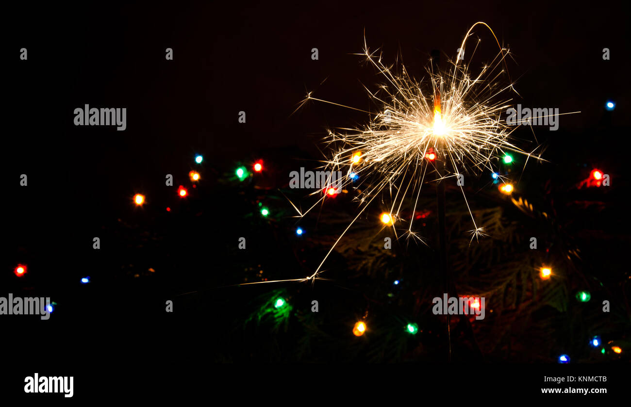 Sparkler and Christmas lights as an ideal background Stock Photo Alamy