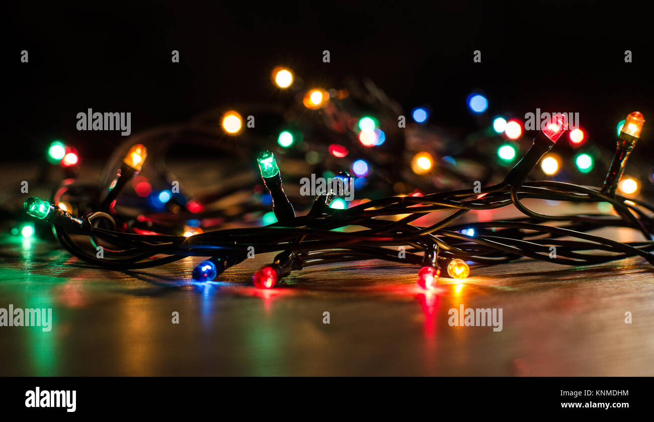 Christmas lights on a tree in different colors are classic symbol of  Christmas Stock Photo - Alamy