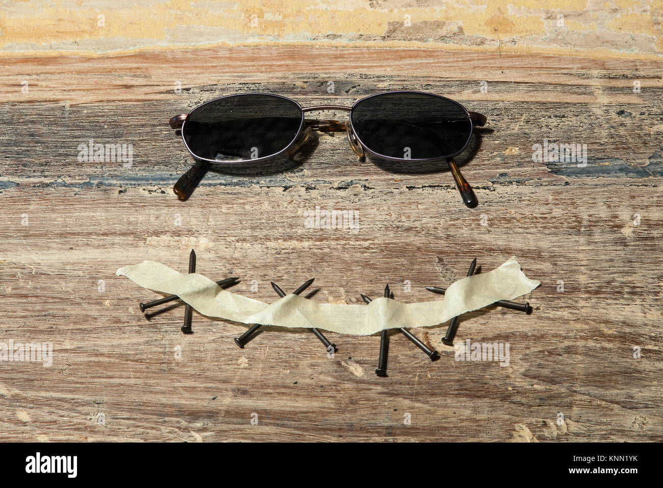 portrait with sunglasses, tape and nails Stock Photo Alamy