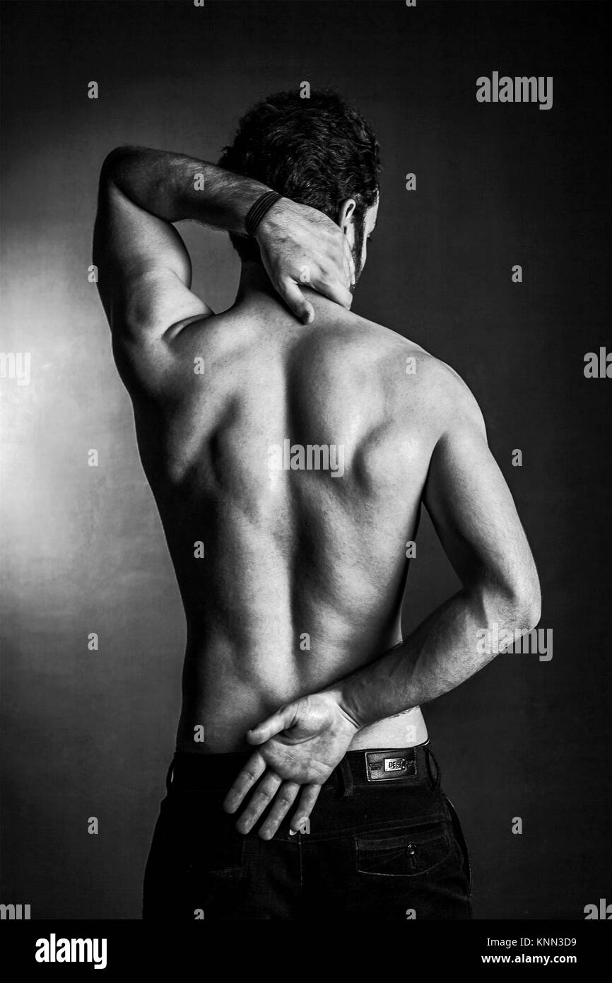 Man body figure showing the back muscles in black and white. Shirtless male  body on black background. Male studio posing to show body muscles Stock  Photo - Alamy