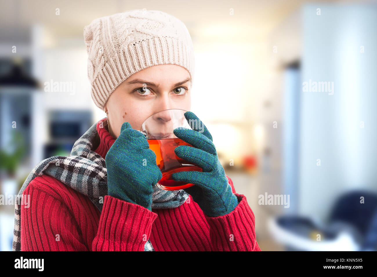 Sick cold woman drinking hot tea indoors at home as heatlhy medicine