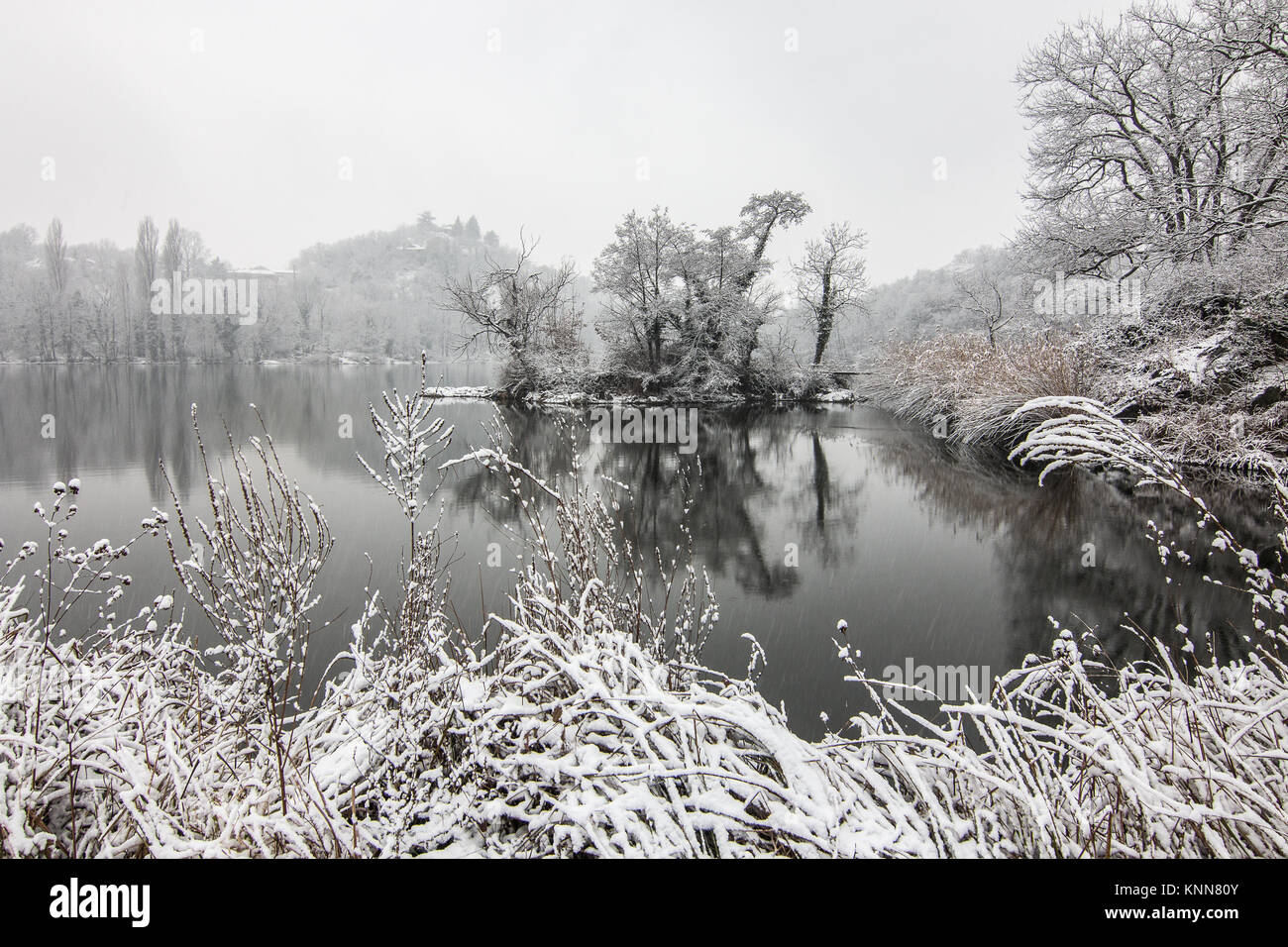Snow y the lake Lago San Michele of Ivrea, province of Turin, in the Piemonte region of Italy Stock Photo