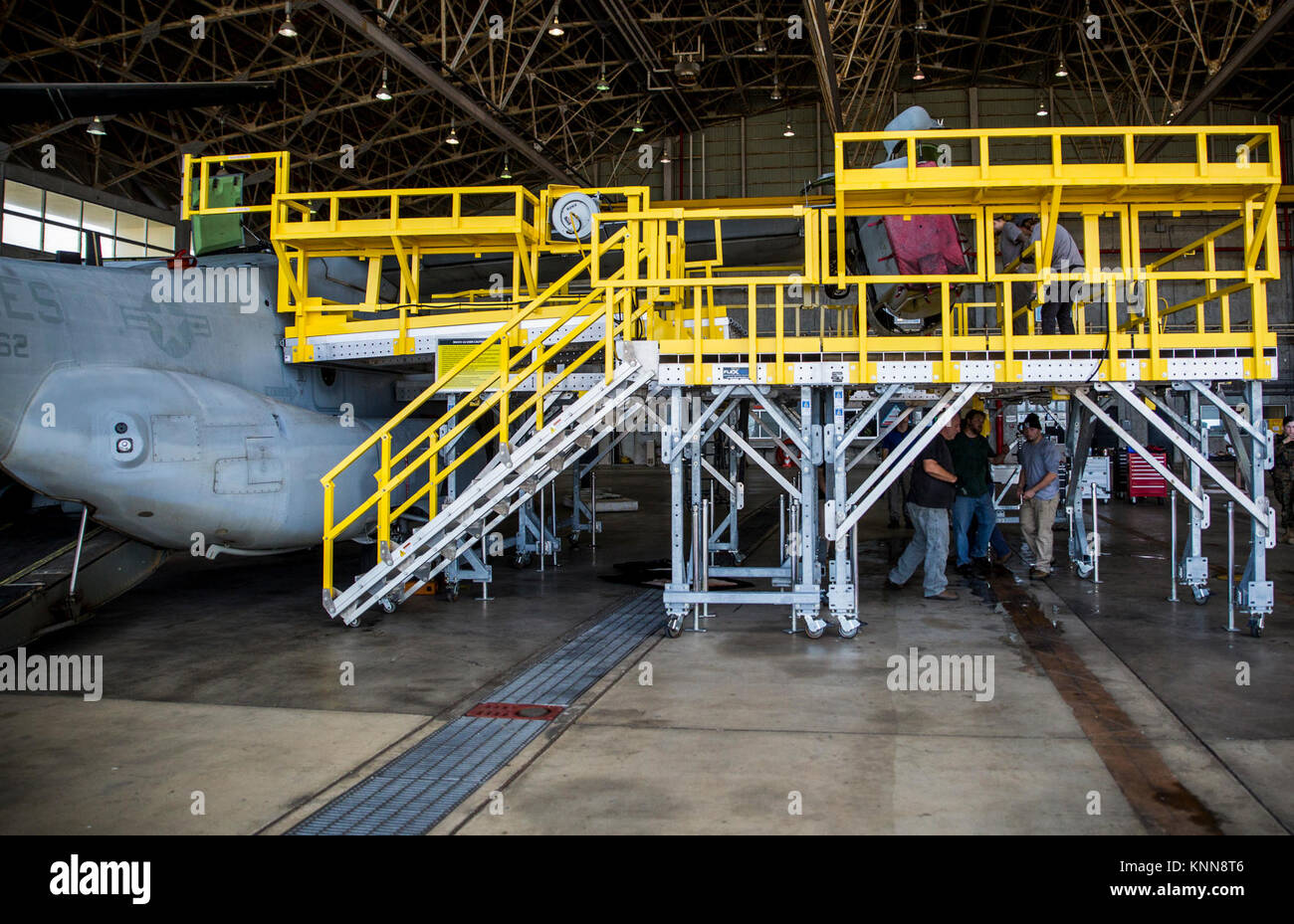 Aircraft Maintenance Contractors Utilize Flexdecks Osprey Wing And Nose  Stand To Maintain An Mv-22B Osprey At Marine Corps Air Station Futenma,  Okinawa, Japan, November 28, 2017. The Platforms Offer Full Nose And