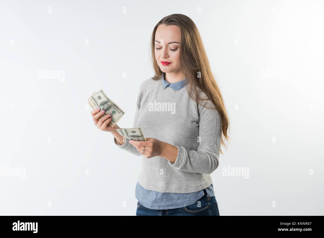 young woman holding dollars cash counting money. Stock Photo