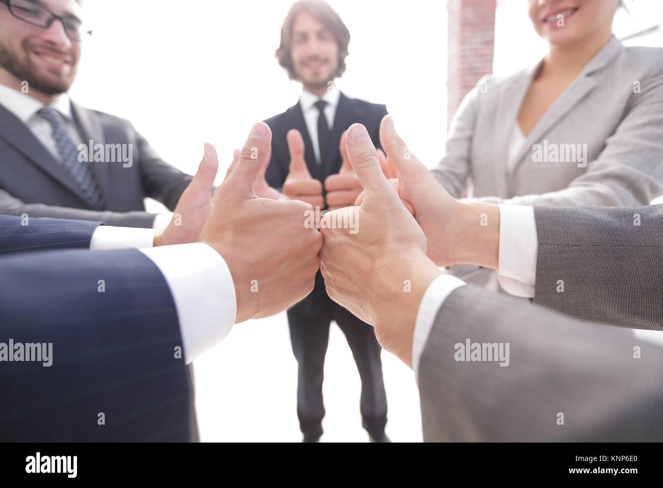 business team showing thumbs up Stock Photo - Alamy