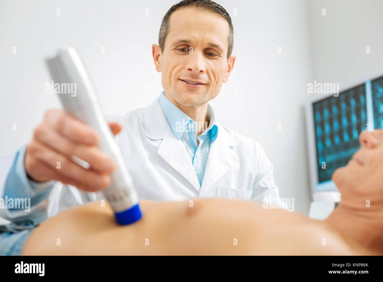 Professional male doctor using medical equipment Stock Photo Alamy