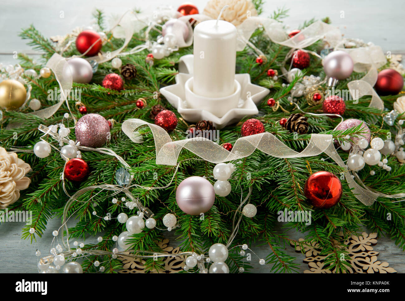 Decorated Advent wreath with white candles on blue wooden background