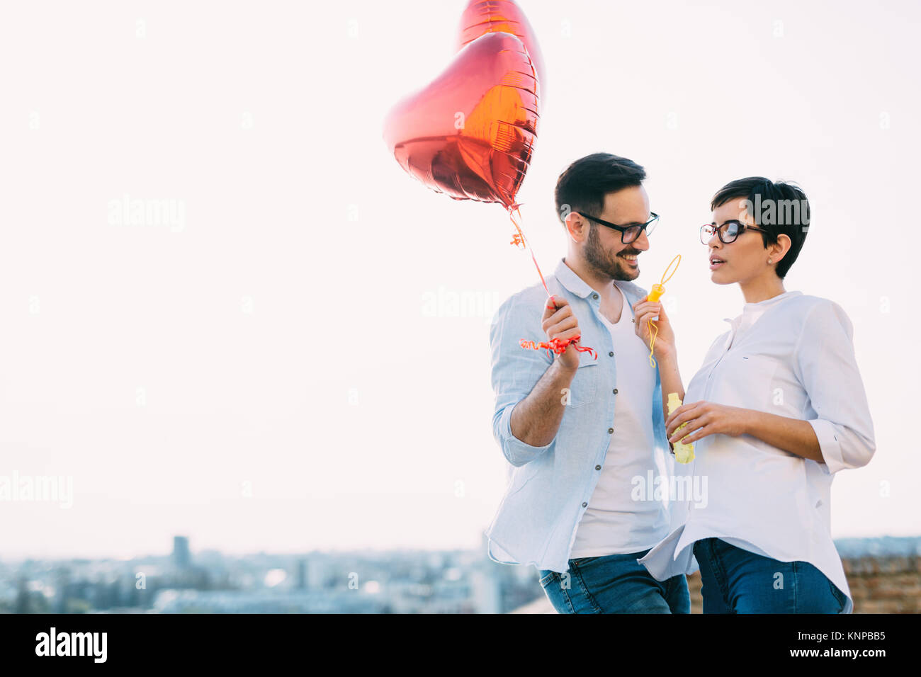 smiling couple in love with balloons on sunset Stock Photo - Alamy