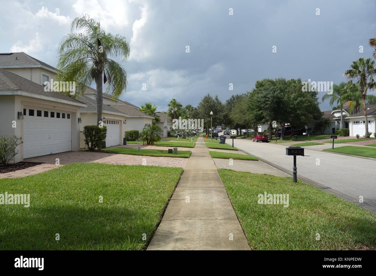 Sidewalk and manicured lawns of luxury villas in Highland Reserve Golf community, Davenport, Florida, USA Stock Photo