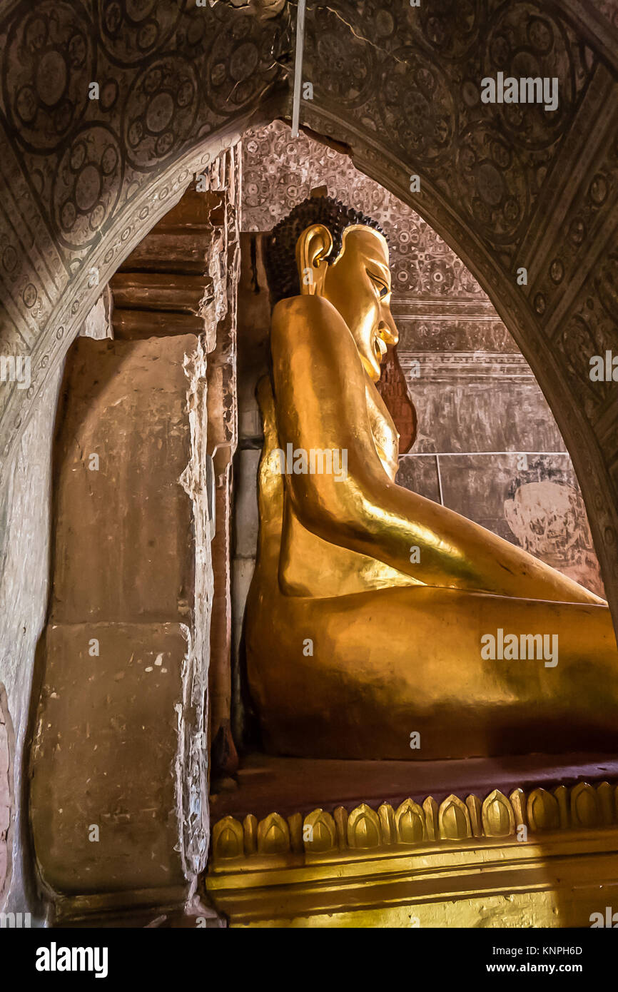 Seated Gold Buddha in the Htilominlo Temple, Old Bagan, Myanmar Stock Photo