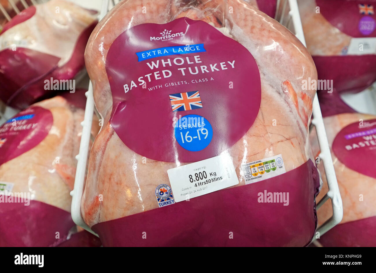 extra large frozen whole basted turkey in supermarket freezer cabinet Stock Photo