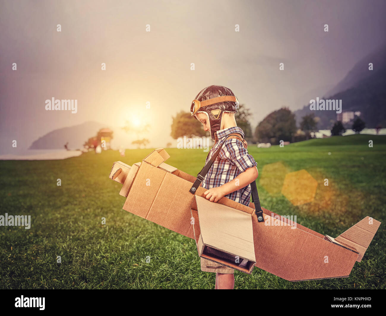 little kid play with cardboard airplane Stock Photo
