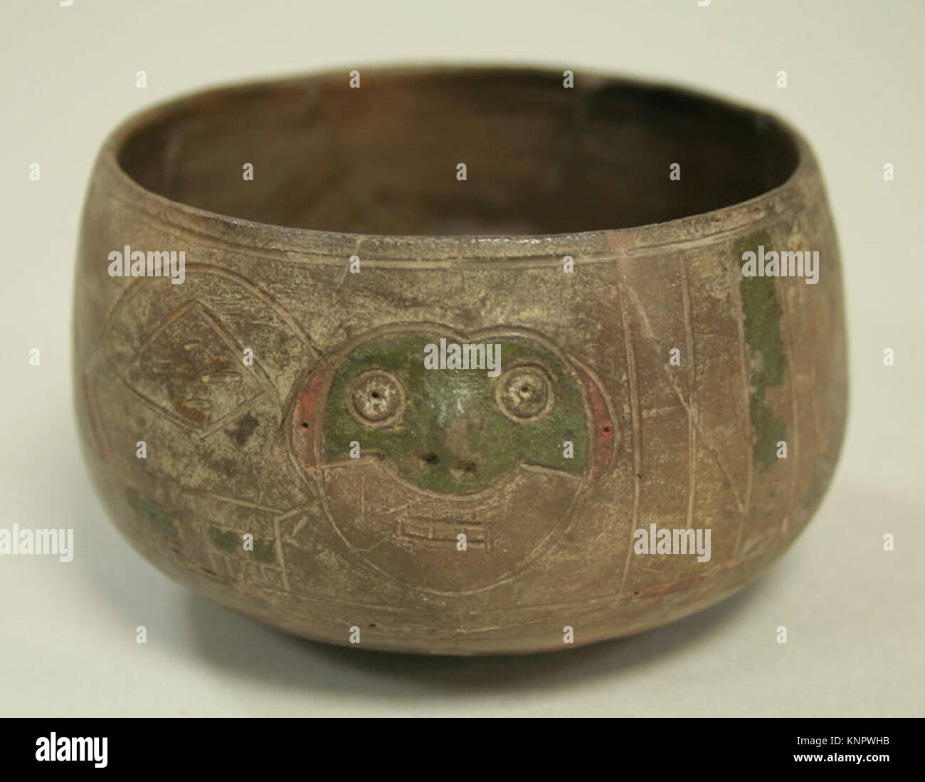 Greyware A greyware ceramic bowl featuring incised monkey designs around the ...