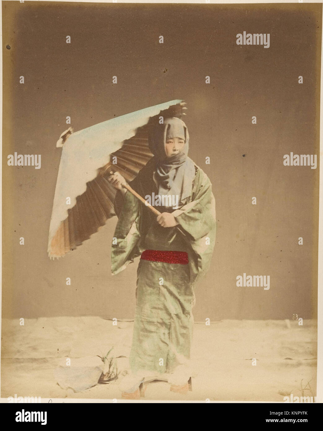 Photograph of a Japanese woman holding a parasol, showing traditional ...