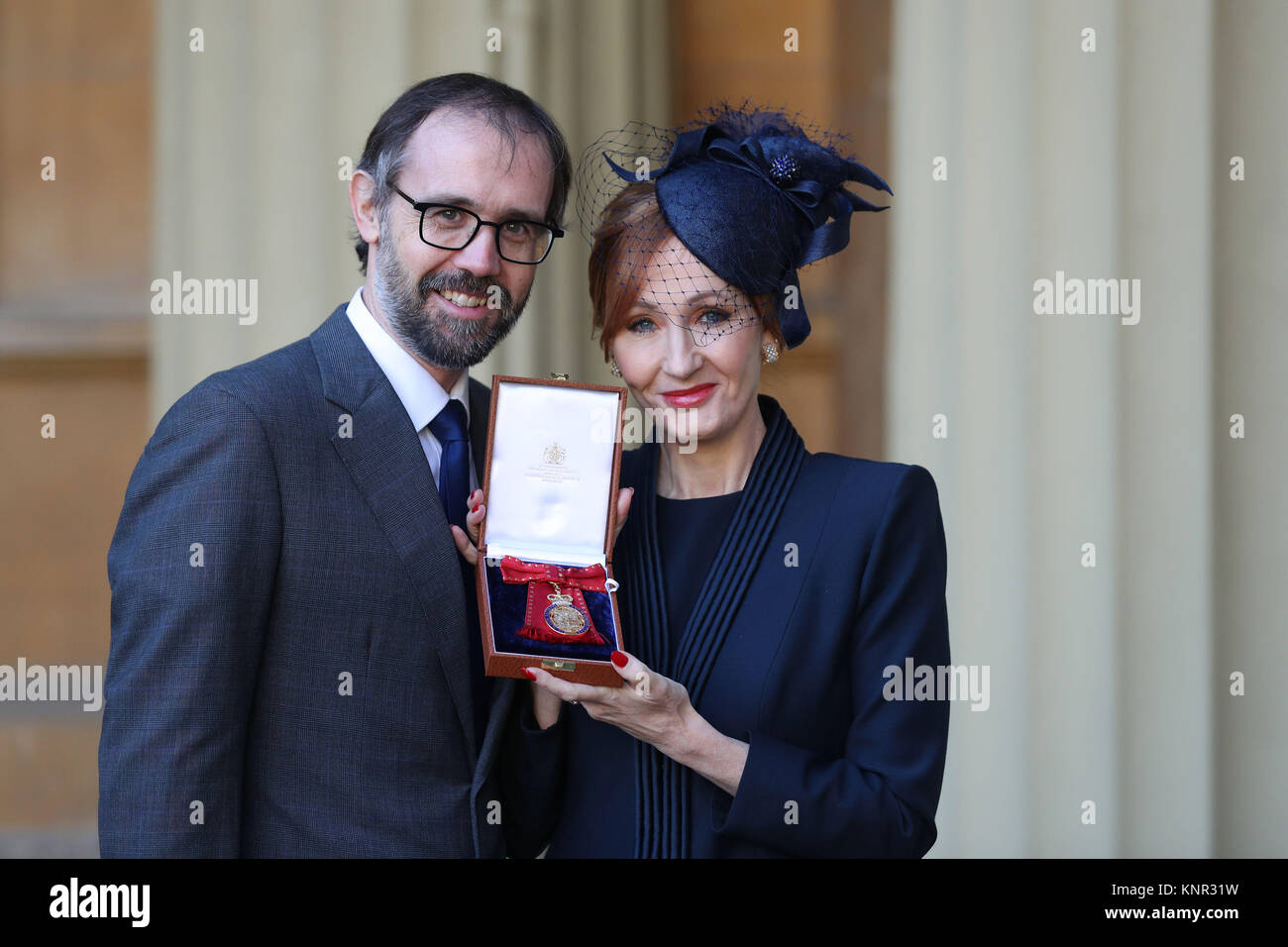 Harry Potter author JK Rowling with her husband Neil Murray after she was made a Companion of Honour by the Duke of Cambridge during an Investiture ceremony at Buckingham Palace, London. Stock Photo