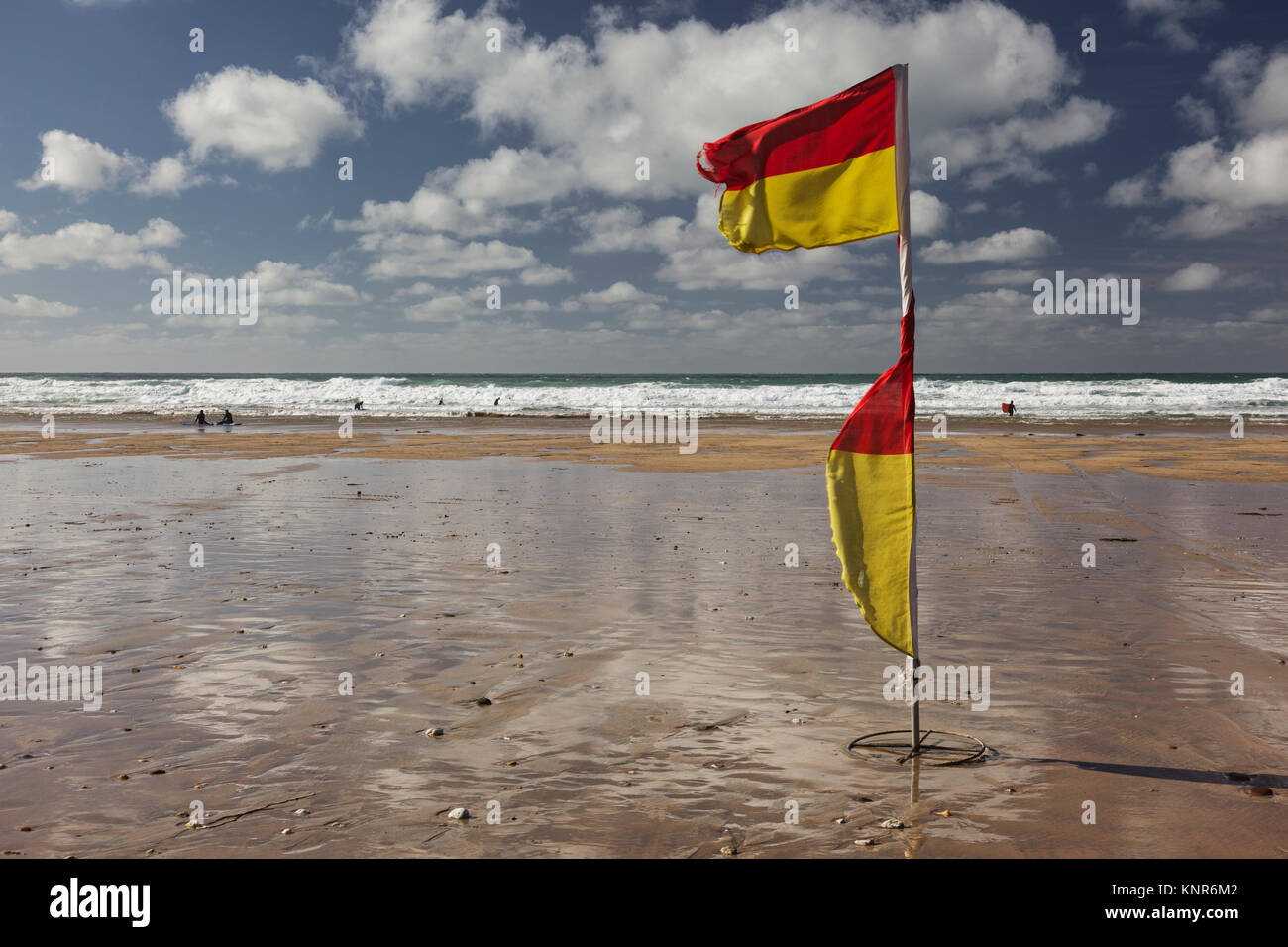 Red and yellow safety flags on Fistral Beach in Newquay, Cornwall