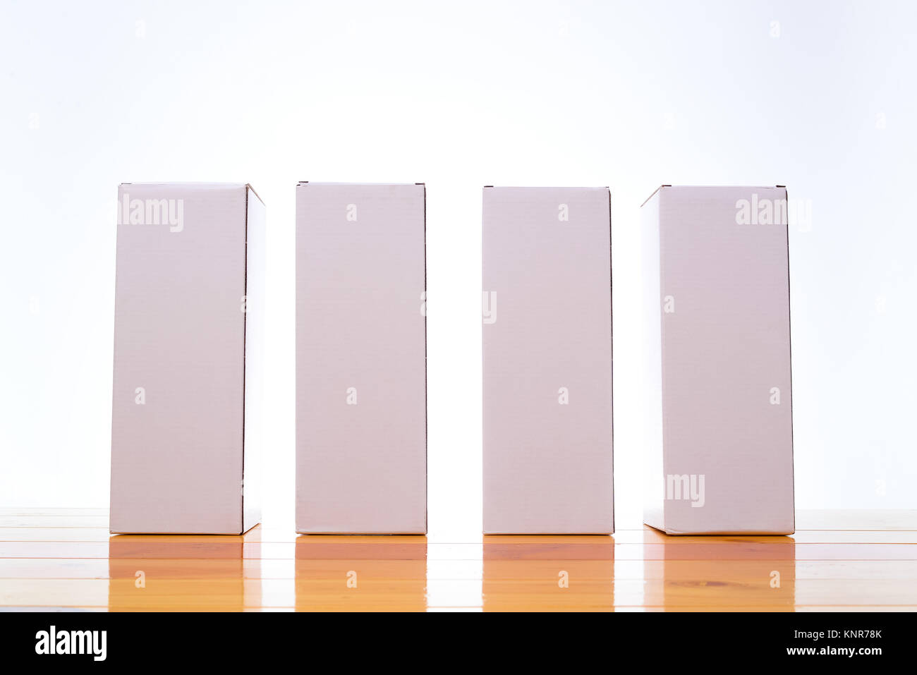 Empty four Package white cardboard box mock up for long items on bright ...