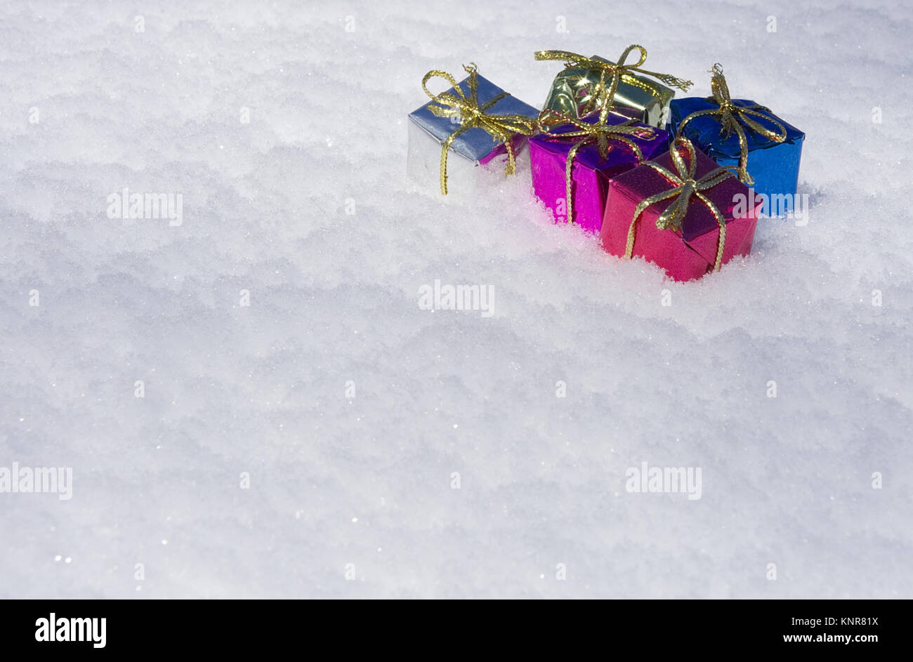 Colorful Christmas Presents in Snow Stock Photo