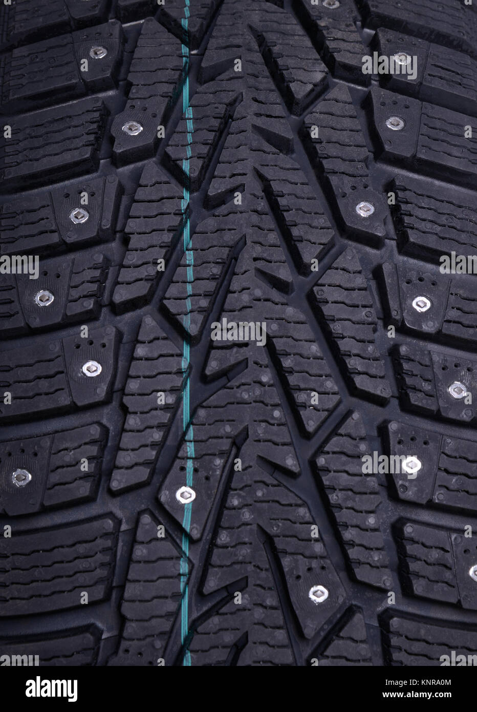 Spikes on a winter tire, close-up Stock Photo