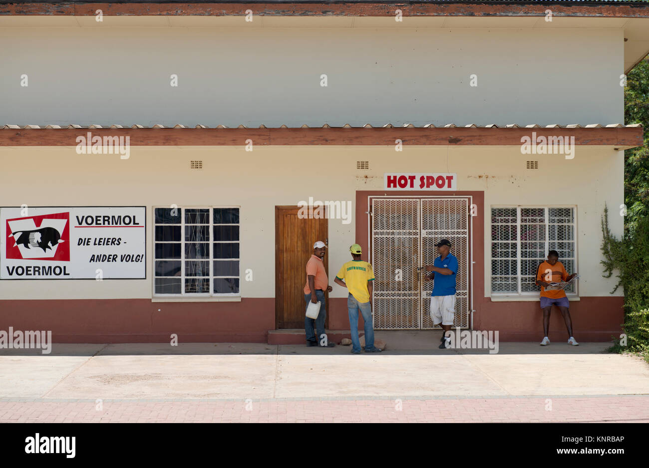 Men around closed shop Stock Photo