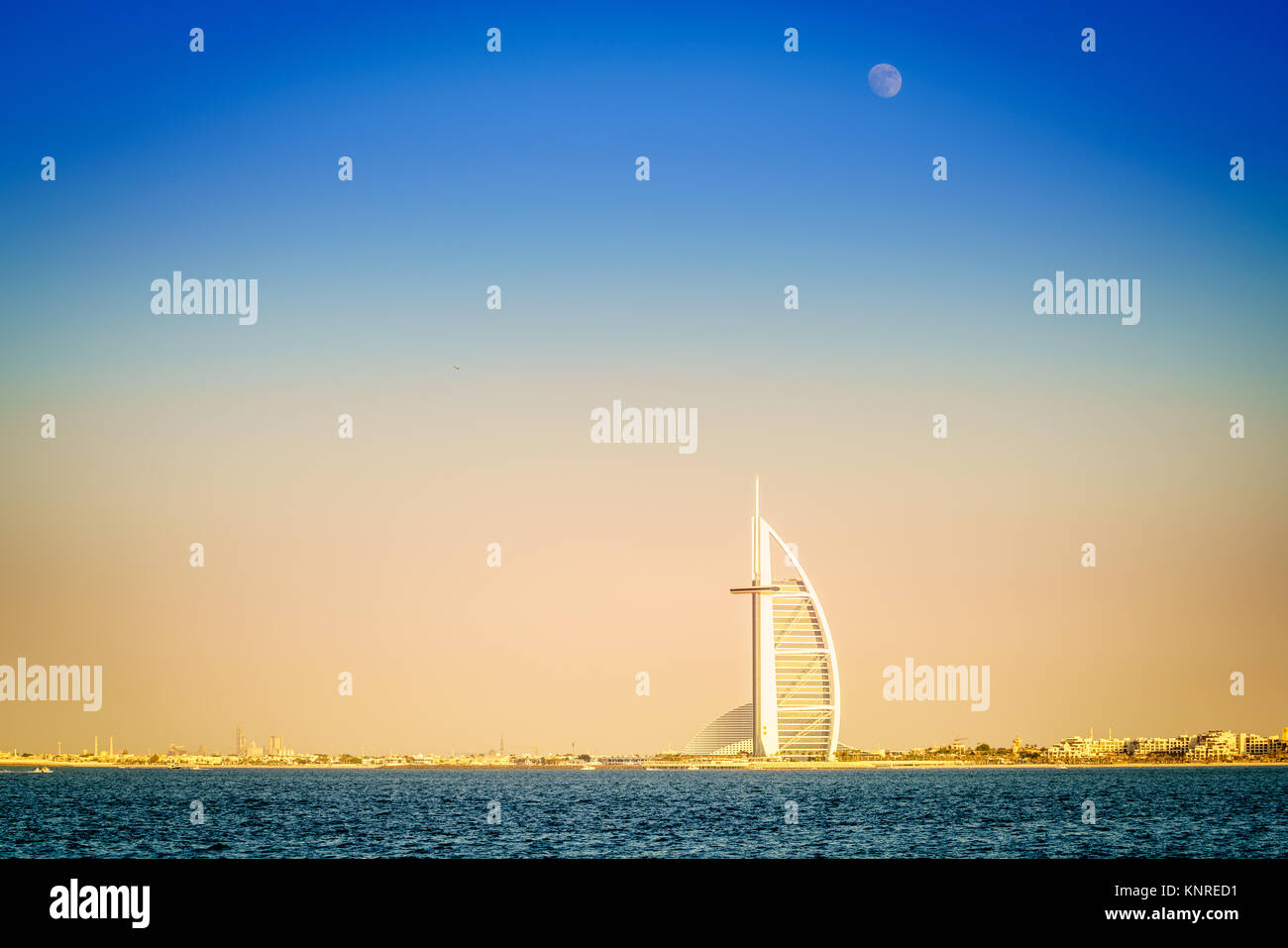 Dubai, UAE, November 12, 2016: moon is rising over Burj Al Arab - the world's only 7-star luxury hotel Stock Photo