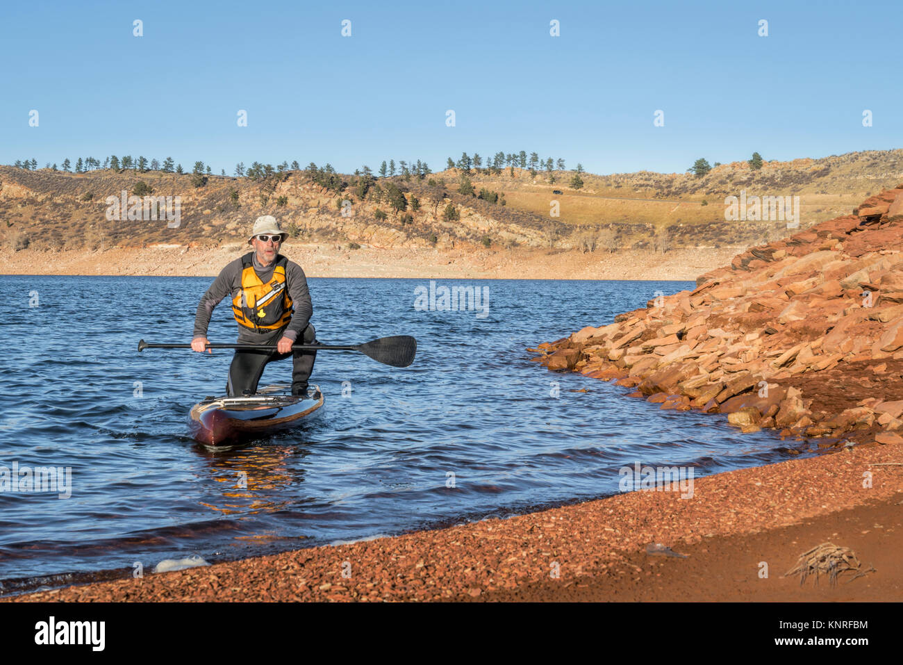 senior male paddler on stand up paddleboard, Horsetooth Reservoir with