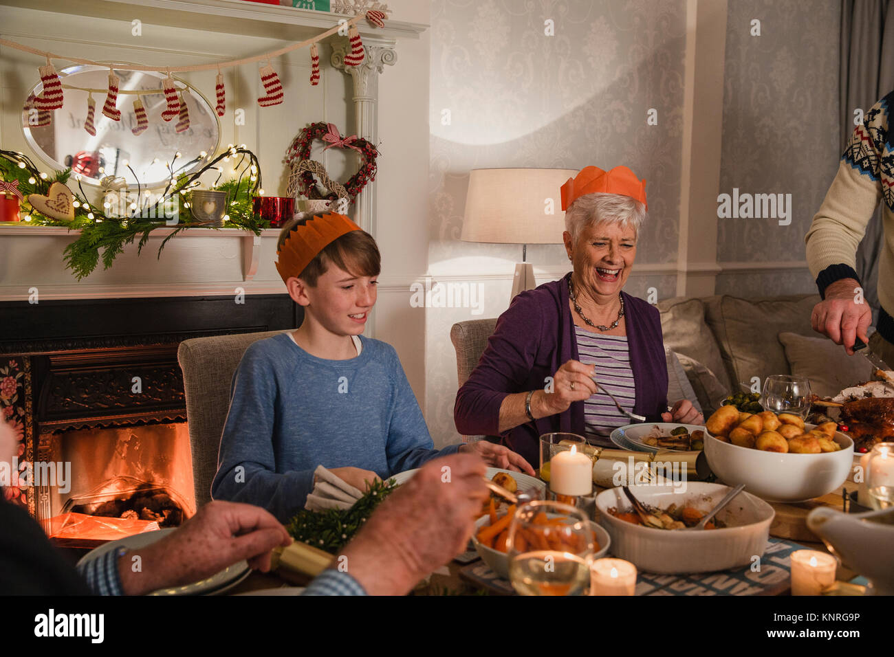 Point of view shot of a family christmas dinner. Everyone is filling their plates with food. Stock Photo