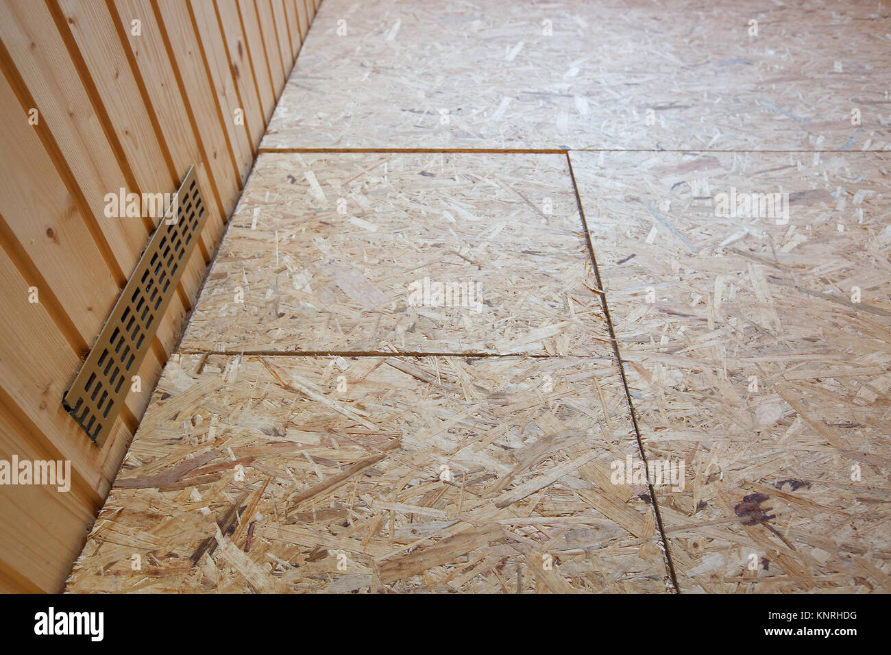OSB boards (flakeboards) laid on floor as preparation for installing parquet. Professional work, DIY, home improvement and renovation, carpentry conce Stock Photo
