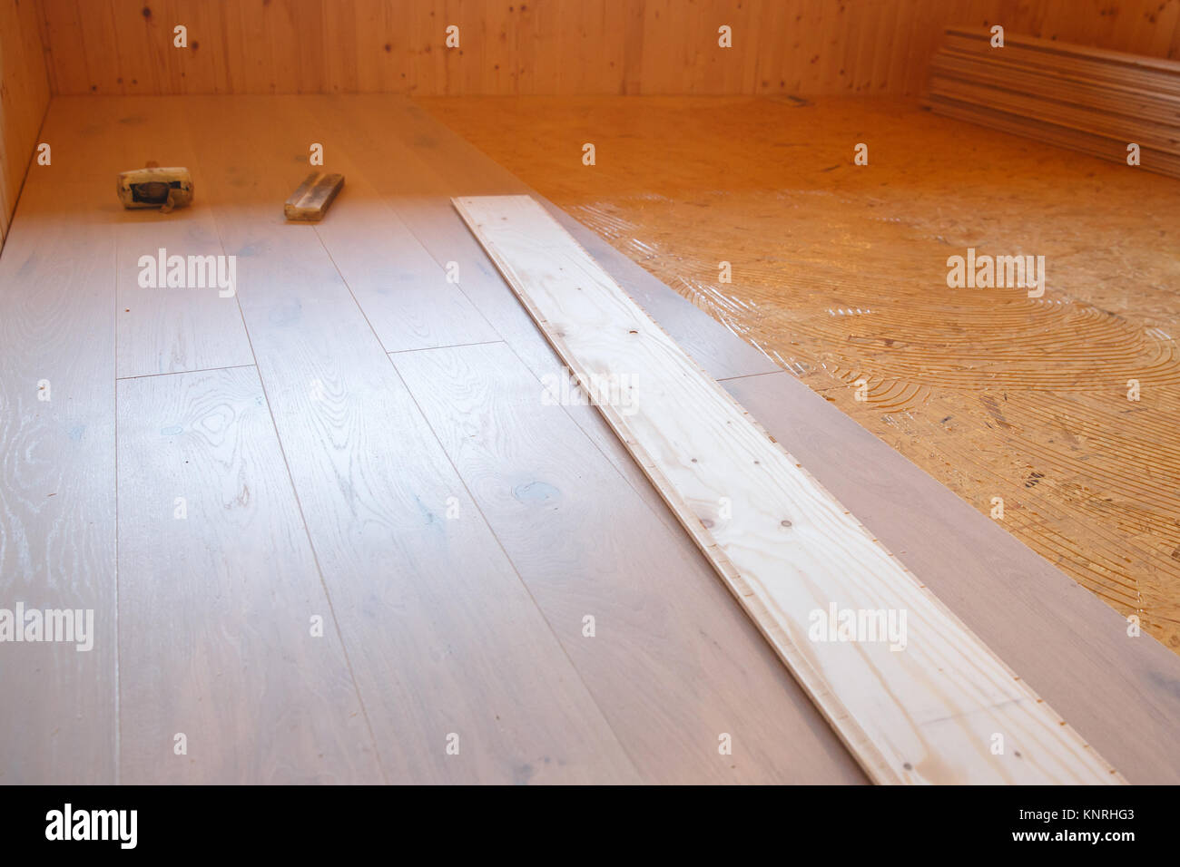 Laying of new parquet flooring in progress, adhesive primer spread on