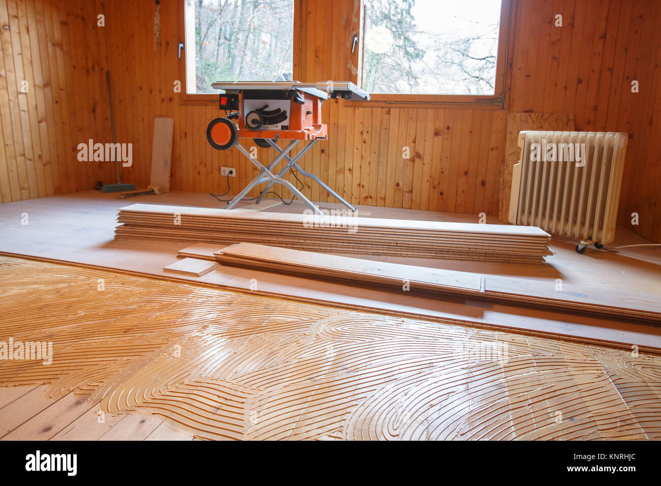 Laying of new parquet flooring in progress, adhesive primer spread on