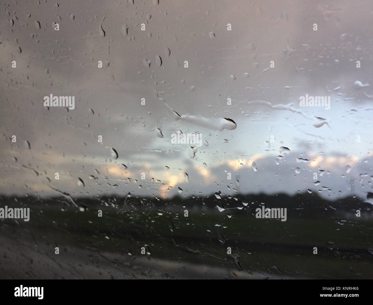 Raindrops on a window as the train passes the fields. Location: The Netherlands Stock Photo