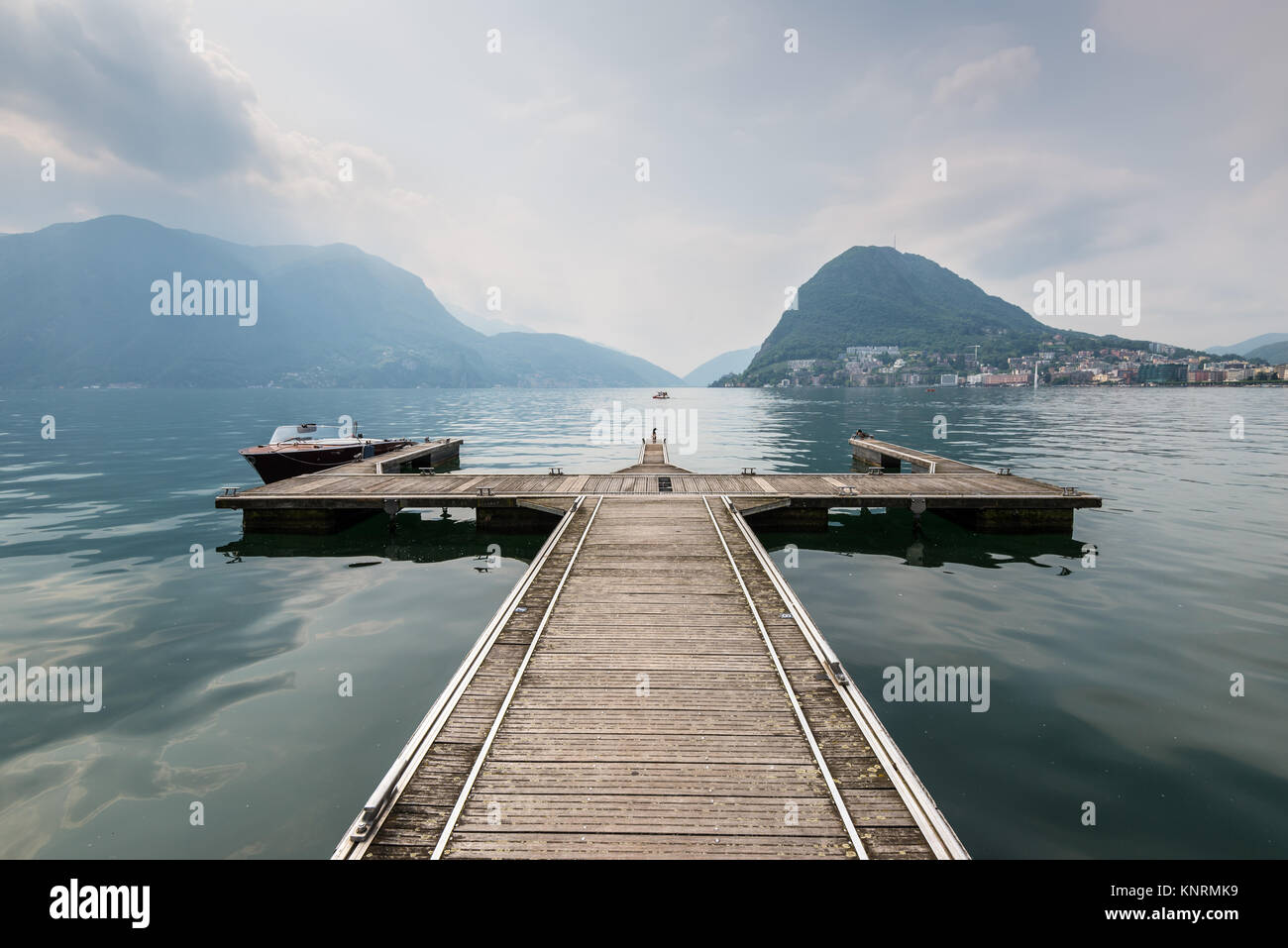 Boat pier on the Lake Lugano, Switzerland. European vacation, travel and nautical concept. Stock Photo