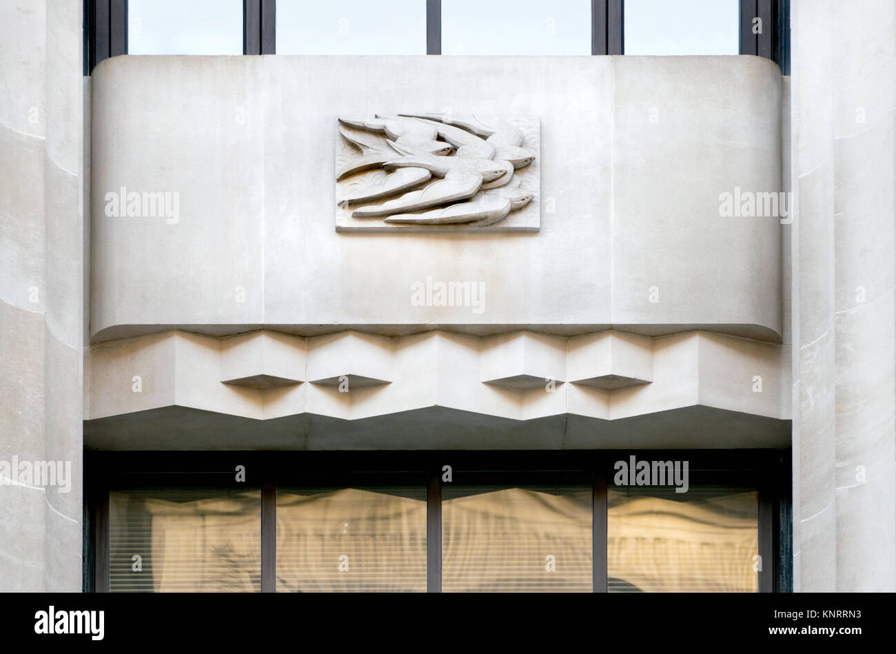 London, England, UK. Peterborough House / former Daily Telegraph Building at 135-141 Fleet Street. Swallows - carved stone base-relief on the facade Stock Photo