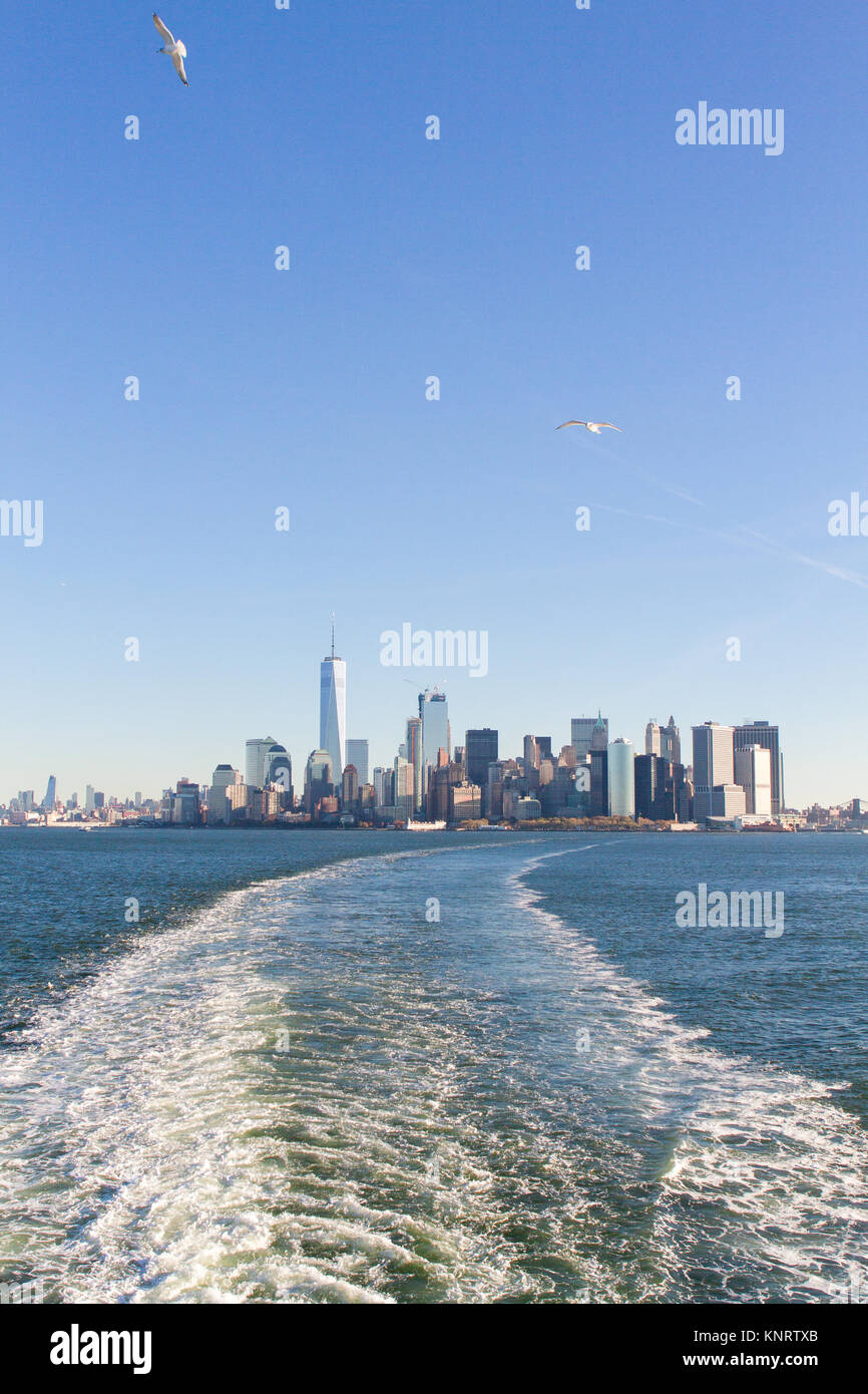 View of New York City Lower Manhattan skyline from boat in New York Harbor Stock Photo