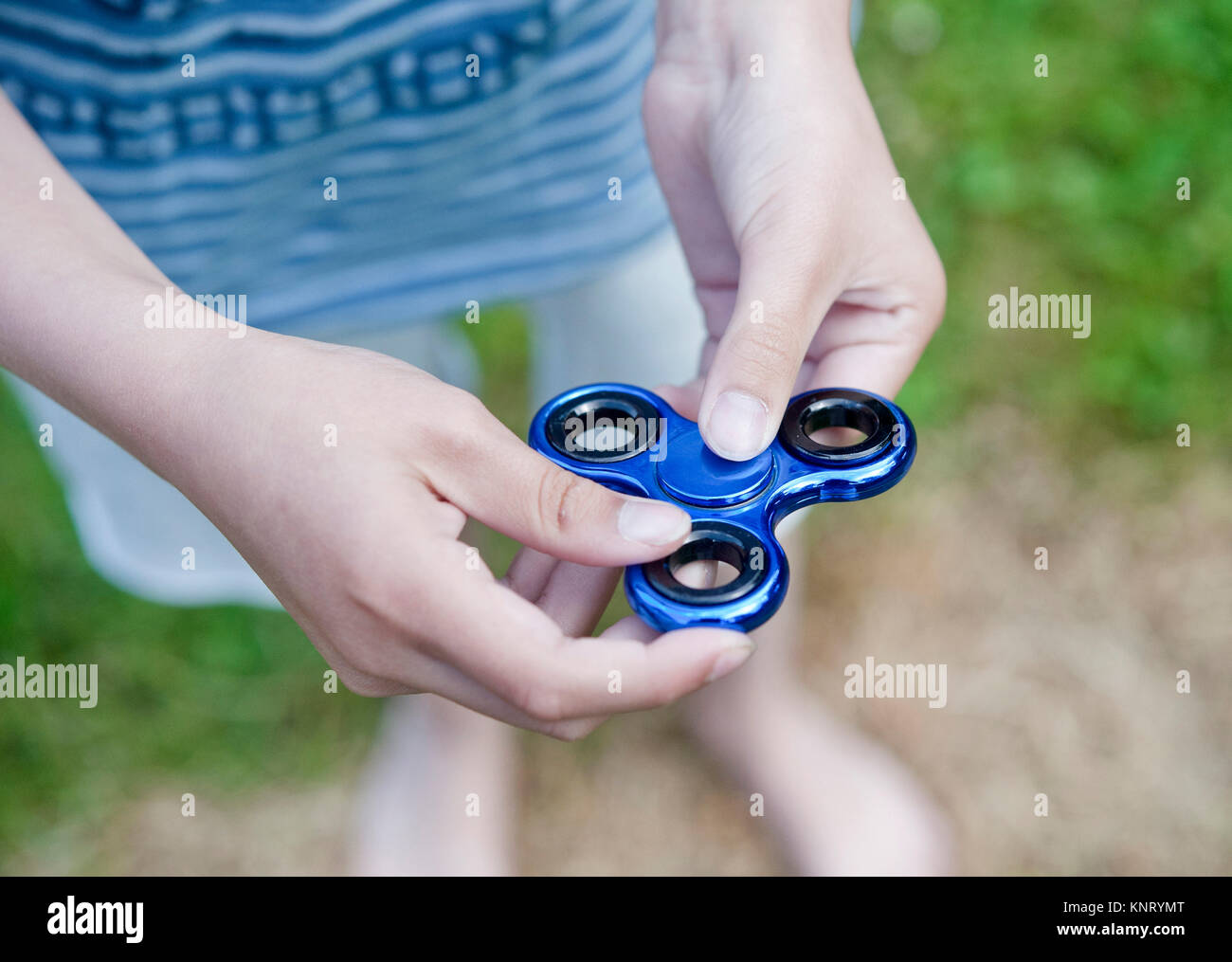 Hand Spinner, also known as fidget spinner, a finger toy that enhances concentration. It's said to have therapeutic value and improve concentration Stock Photo