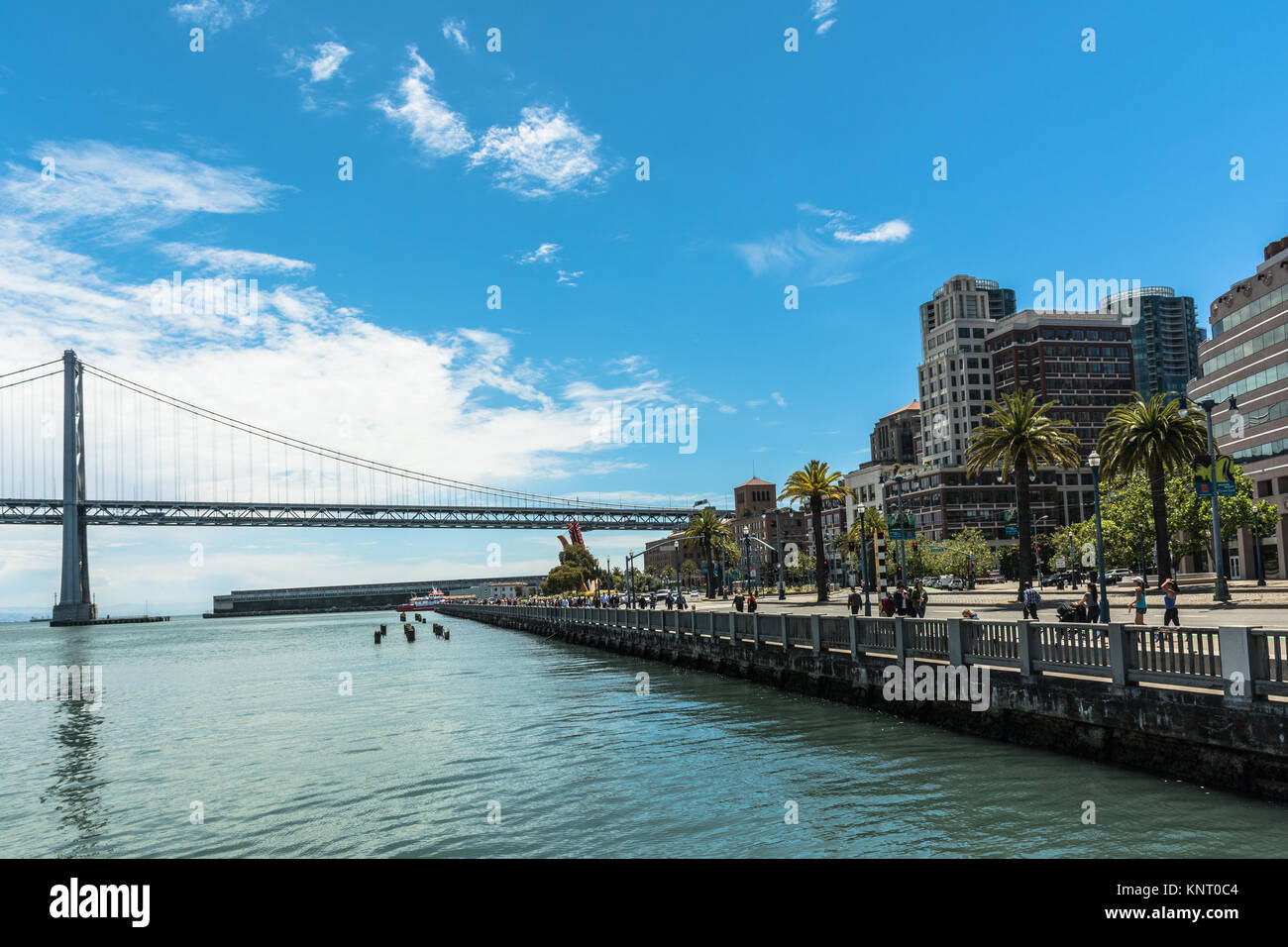 The boardwalk along the Embarcadero and the Bay Bridge in San Francisco Stock Photo