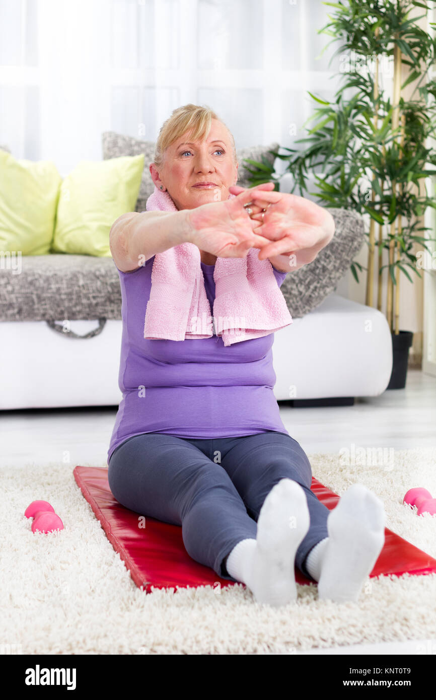 senior woman doing stretching exercises Stock Photo
