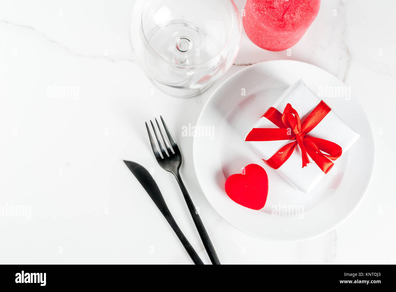 Valentine\'s day table setting with plate, fork, knife, gift box and ... Valentine\'s day table setting with plate, fork, knife, gift box and ...