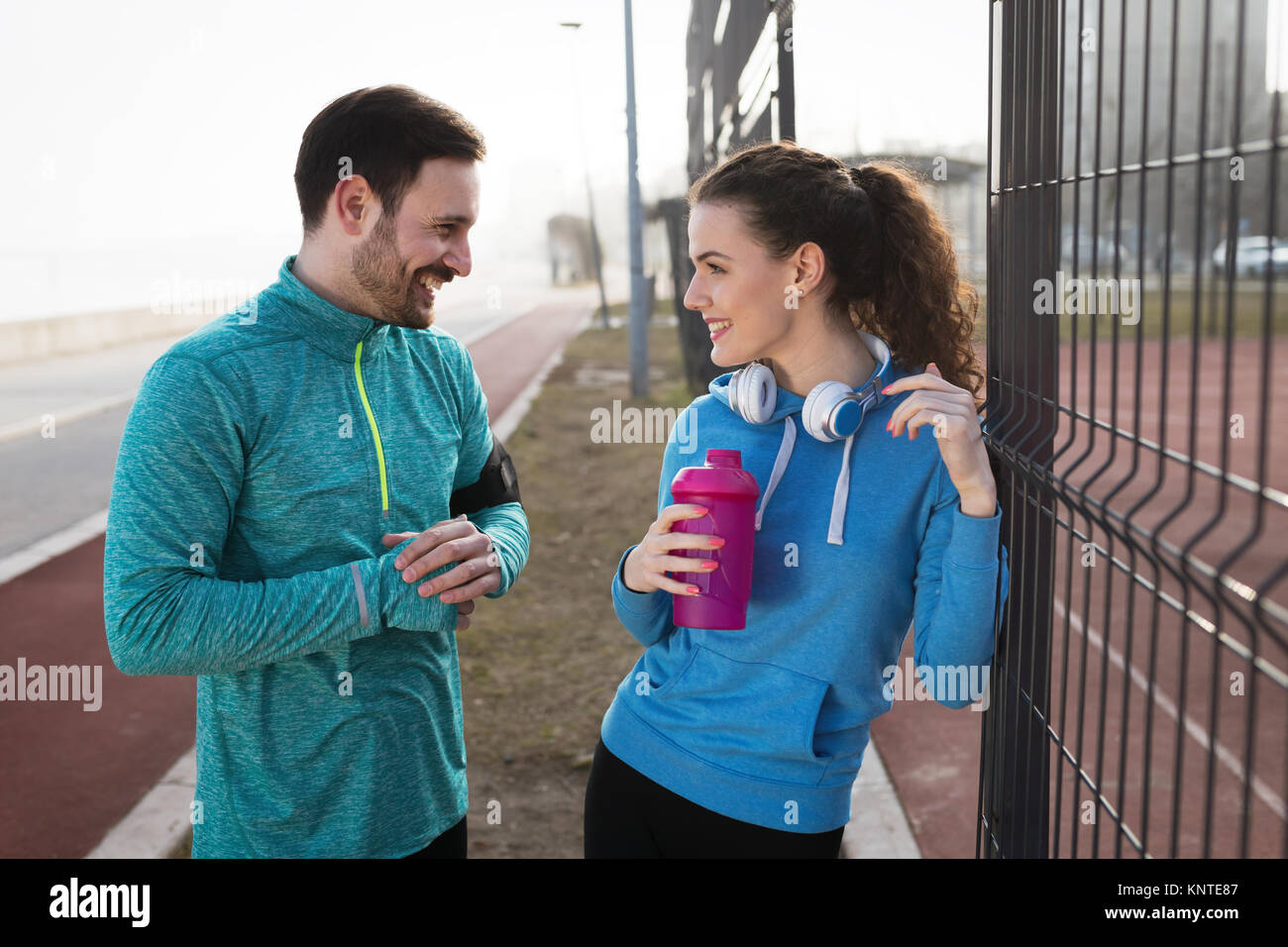 Sportsman and sportswoman flirting outdoor after fitness exercis Stock Photo