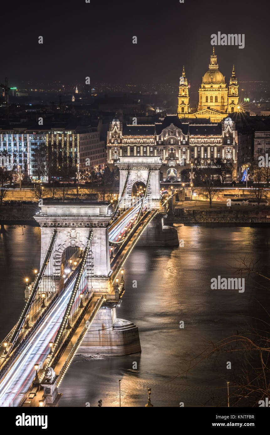 Night View of Chain Bridge over Danube River and St. Stephen's Basilica in Budapest, Hungary. As Seen from Royal Palace in Buda Castle. Stock Photo