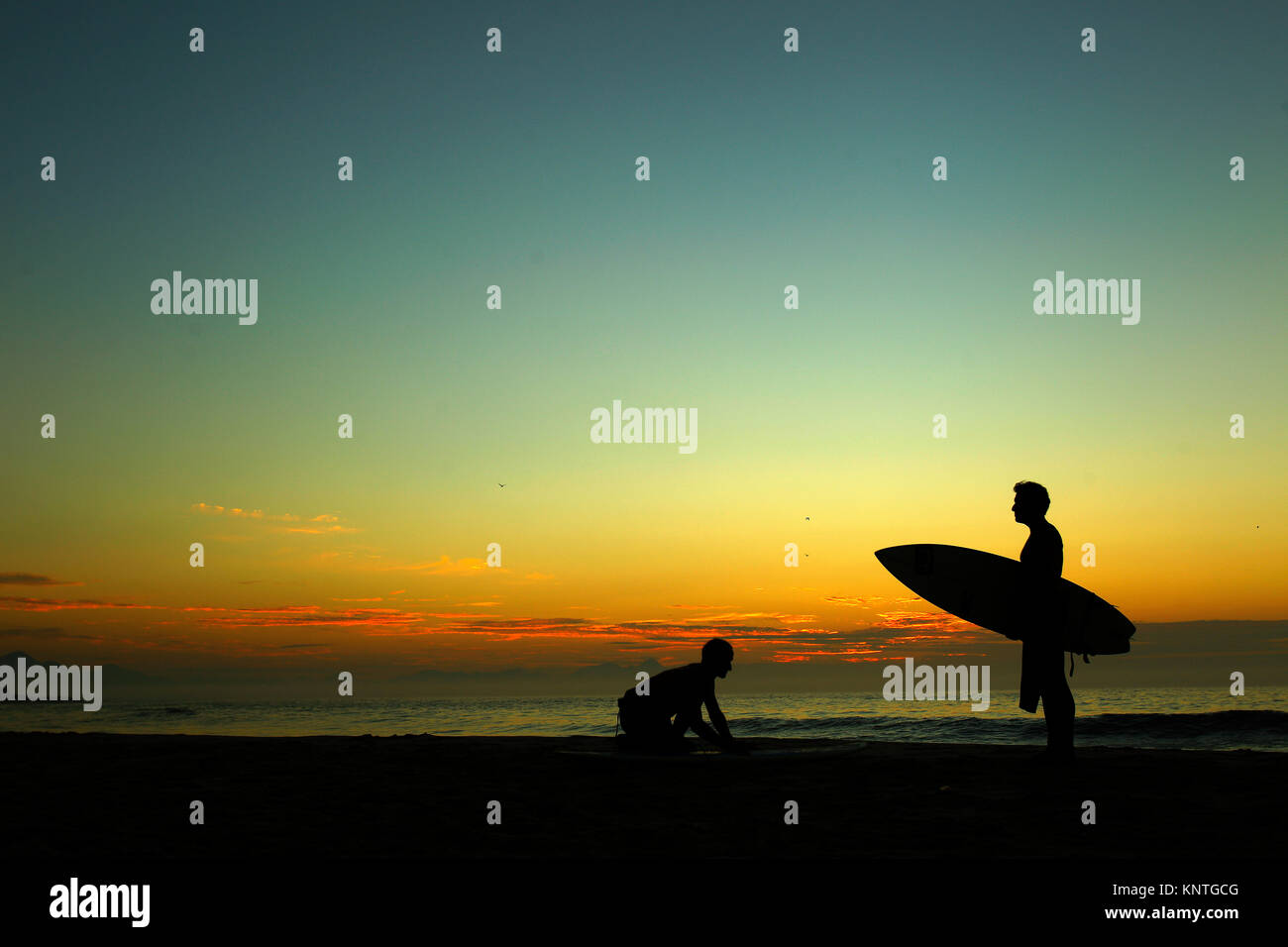 Surfers early morning at Arpoador beach, Rio de Janeiro, Brazil Stock Photo