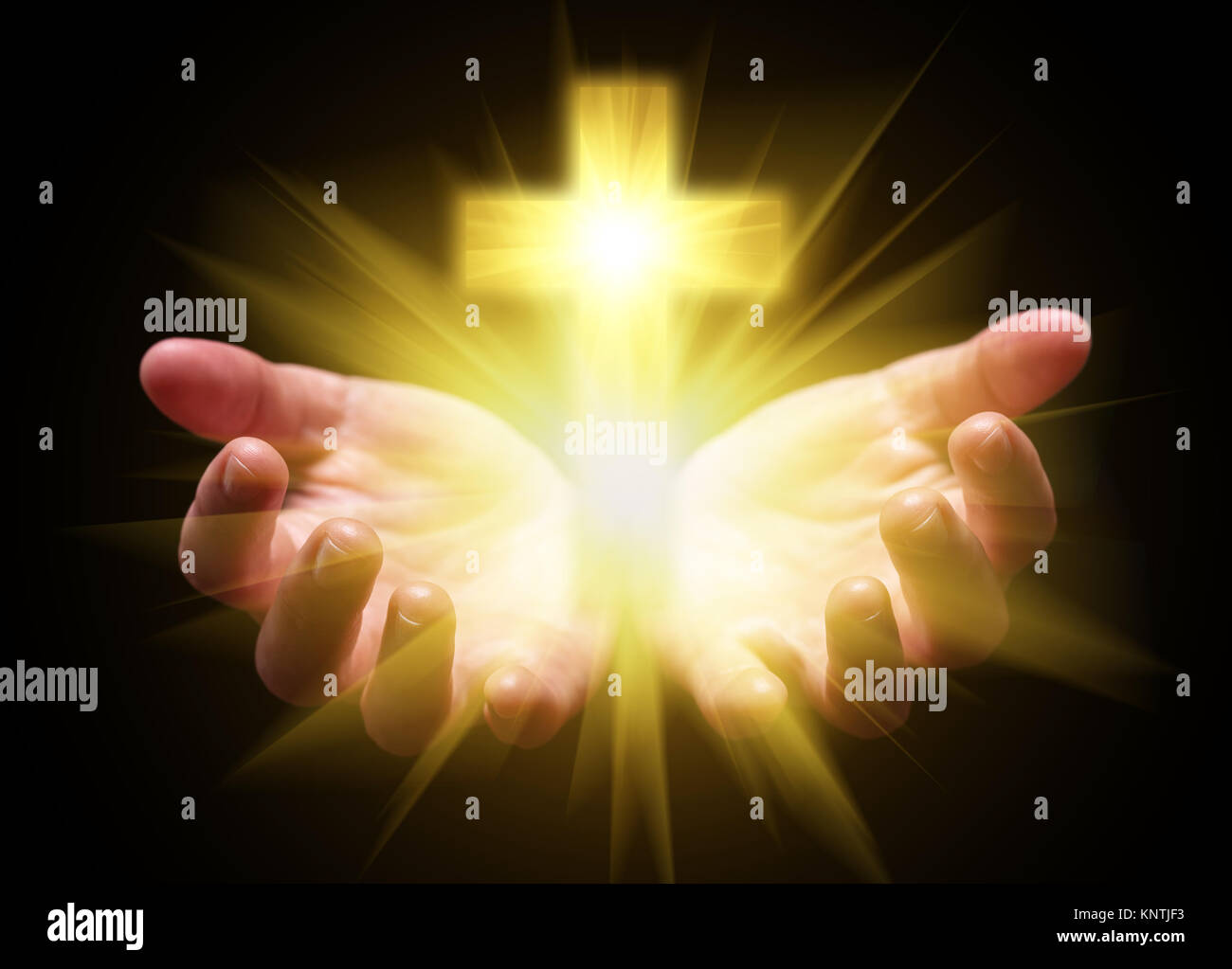 Hands cupped and holding or showing Cross or Crucifix with bright glowing shining light. Christian Christianity Catholic religion divine god celestial Stock Photo