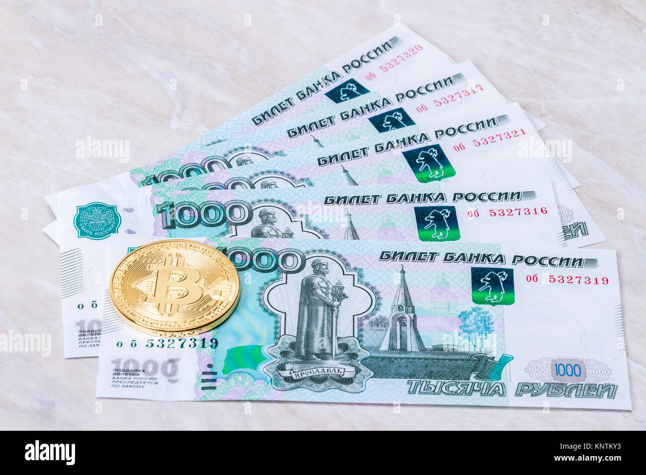 Cryptocurrency coins lying on the russian ruble banknotes. Business concept  of new virtual money Stock Photo - Alamy