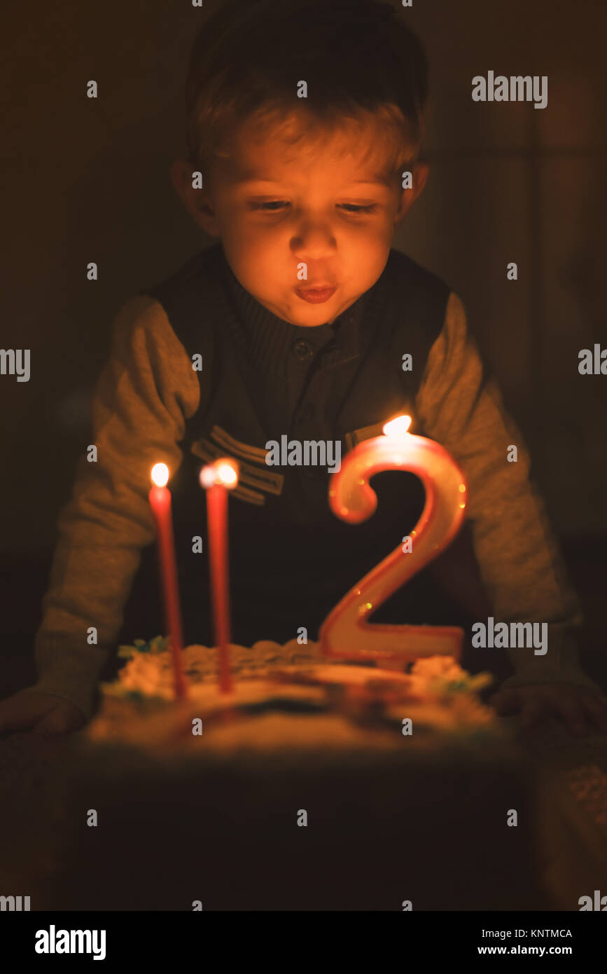 Young boy blowing out candles hires stock photography and images Alamy