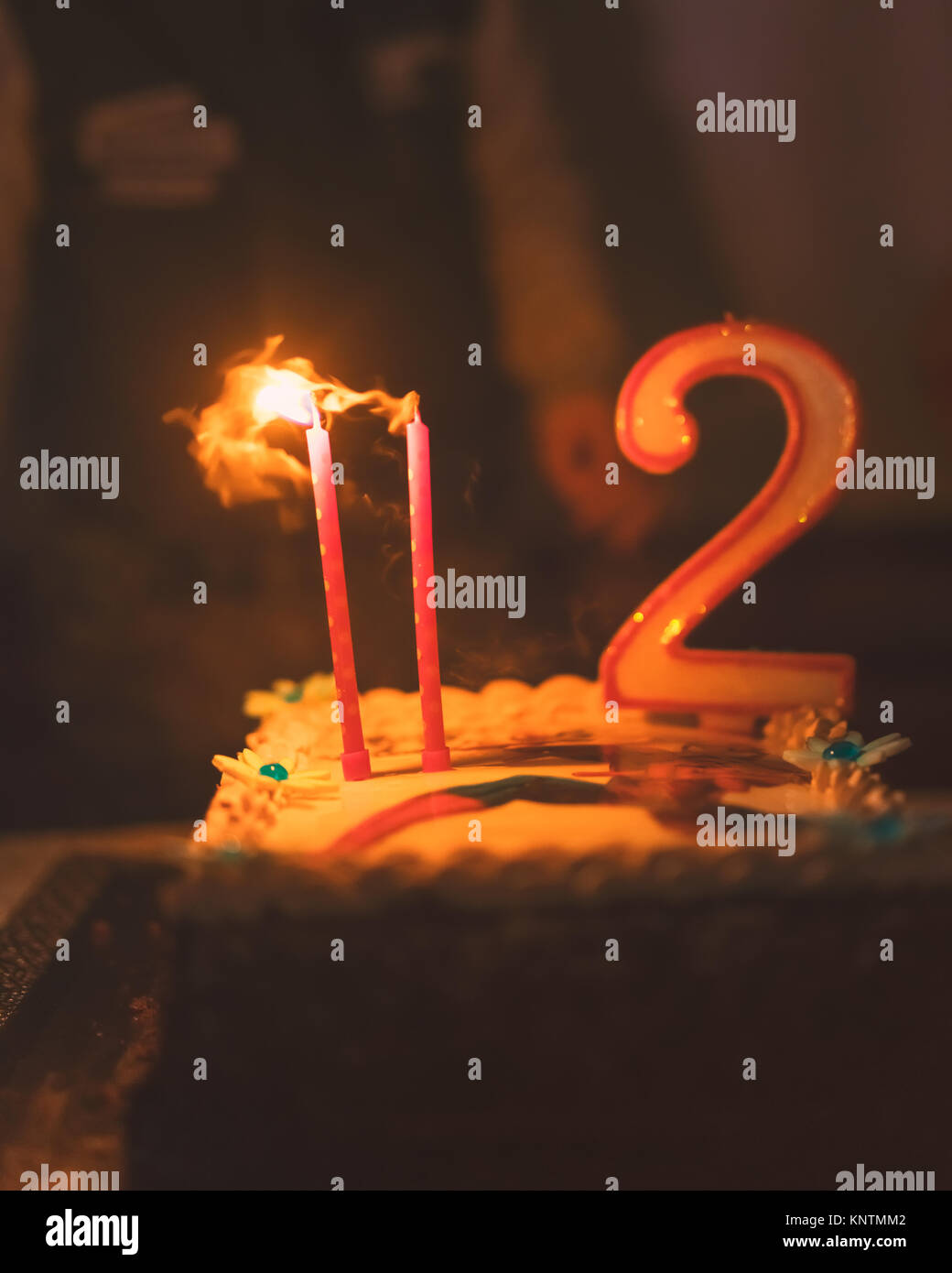 Happy birthday cake with two candles, low depht of focus for dreaming