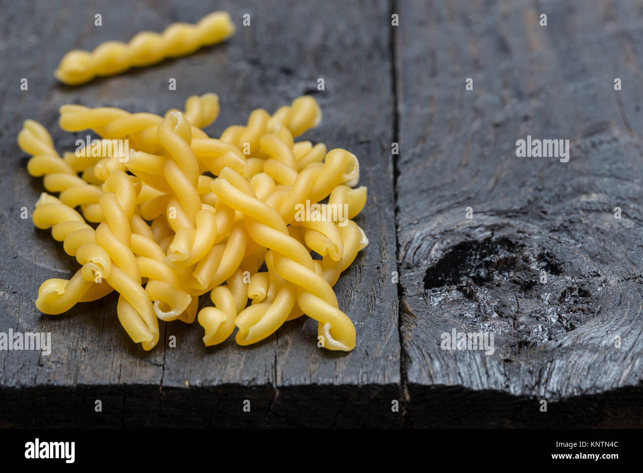 Gemelli noodle on dark rustic wood. Stock Photo