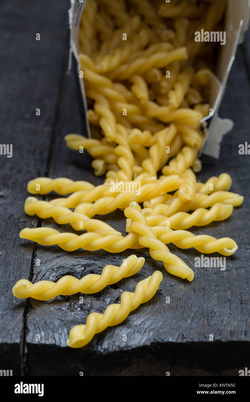 Gemelli noodle on dark rustic wood. Stock Photo