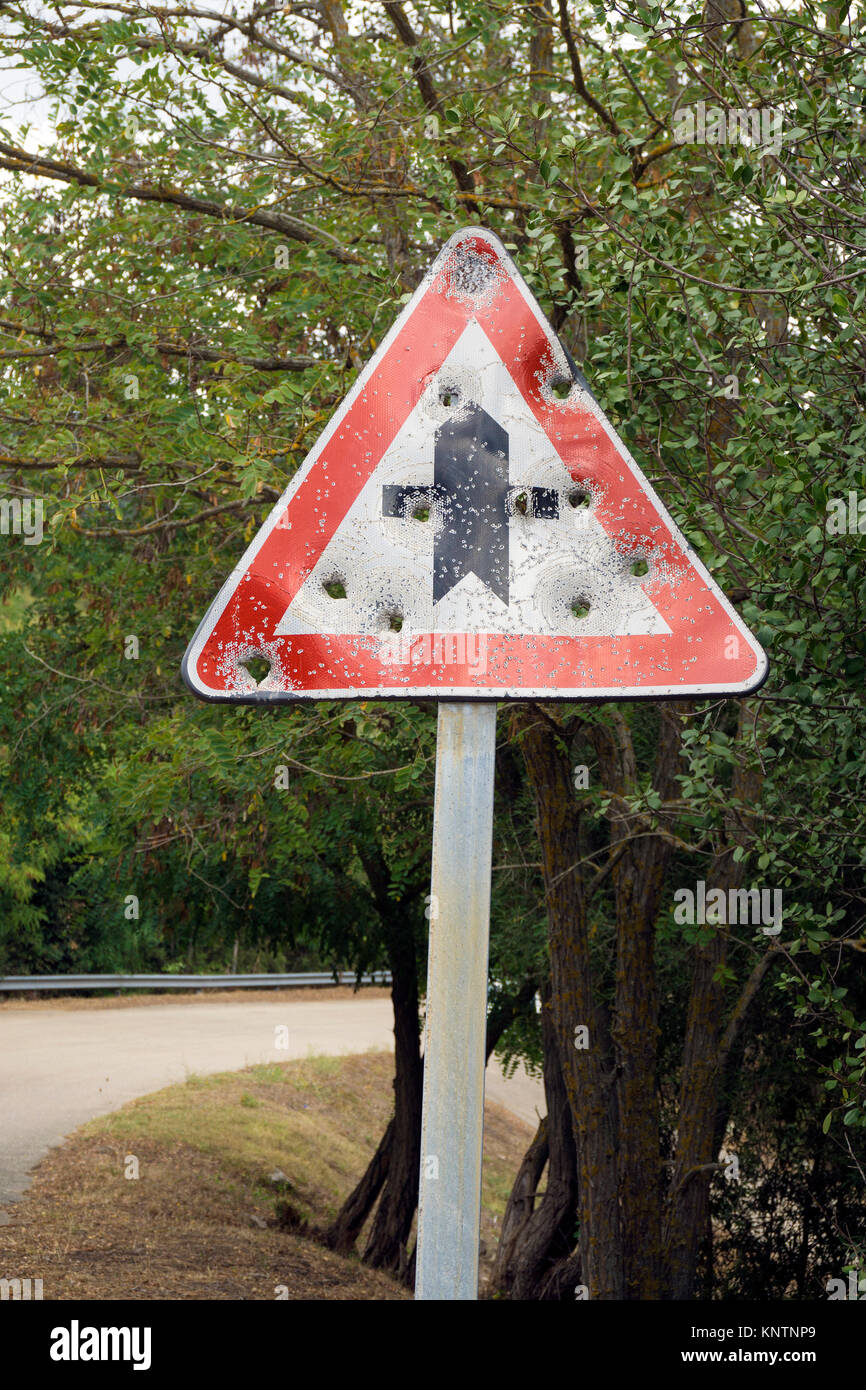 Riddled traffic sign at a road, Gallura, Sardinia, Italy, Mediterranean sea, Europe Stock Photo