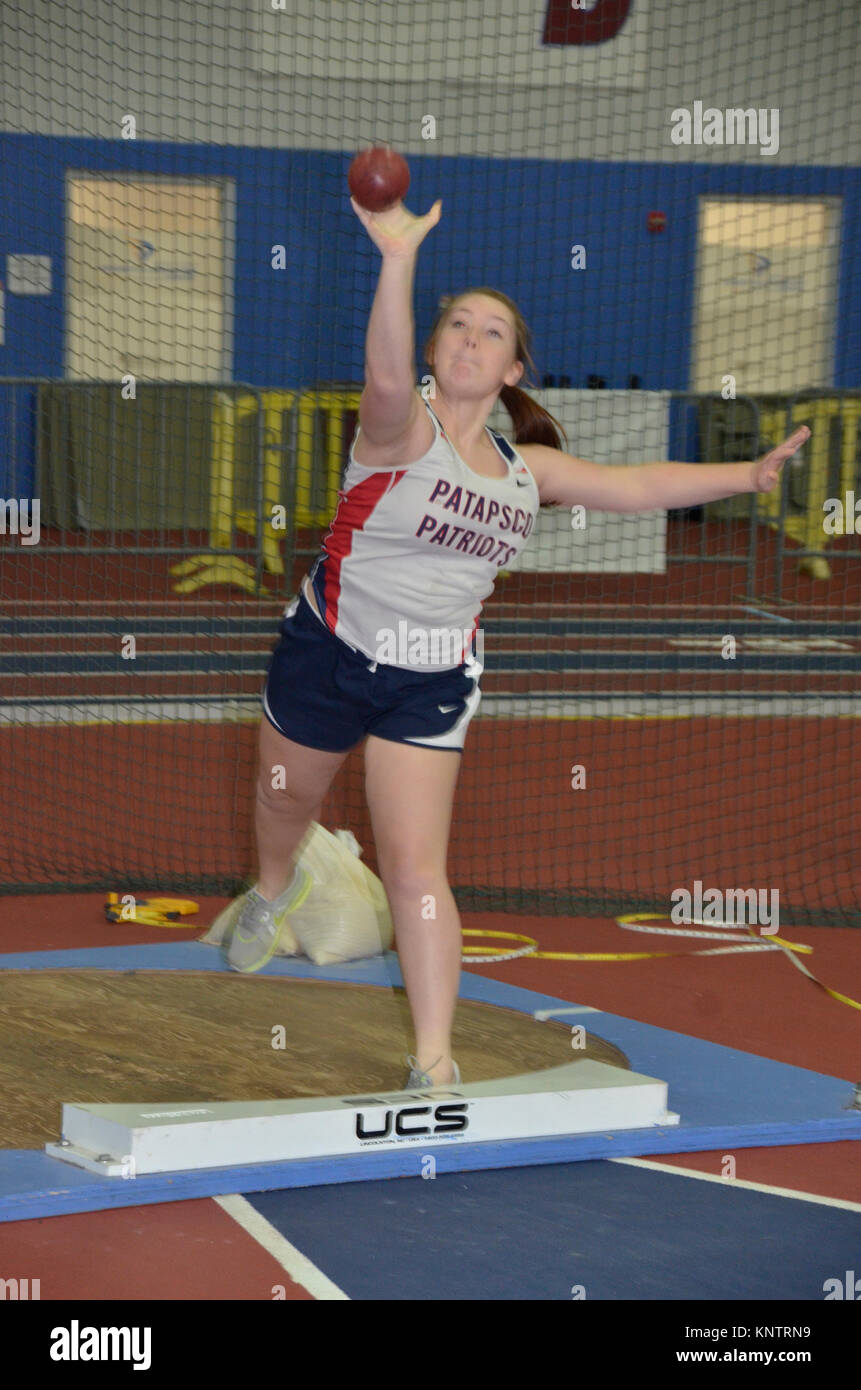 Girl throwing a shot put during a track and field event in Maryland